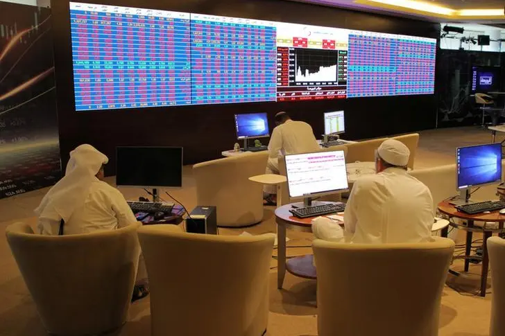 Qatar\\'s traders look at share prices on an electronic display at the Doha Stock Exchange in Doha, Qatar January 8, 2020. REUTERS. Naseem Zeitoon