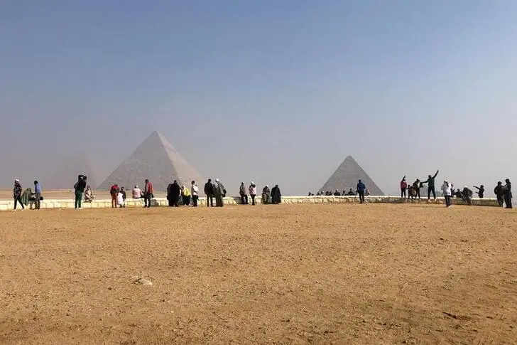Visitors gather to look at the Great Pyramids of Giza, amid the coronavirus disease (COVID-19) outbreak, in Giza, Egypt January 3, 2021.