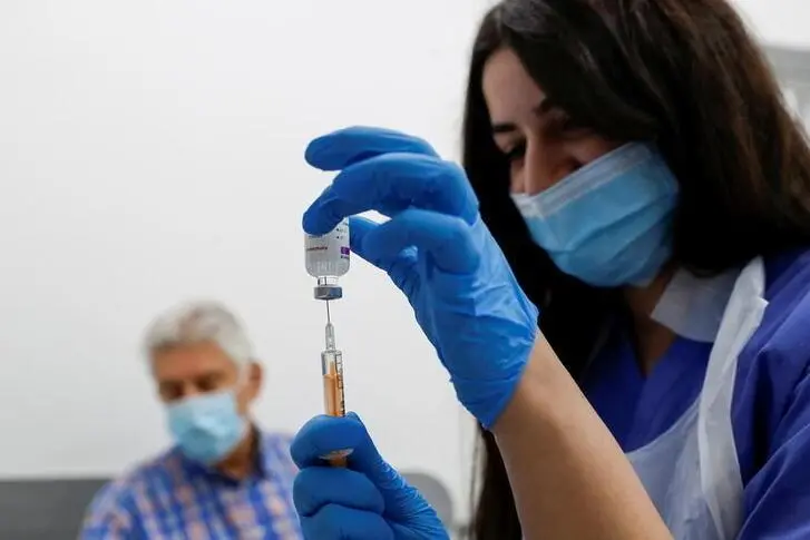 A health worker fills a syringe with a dose of the Oxford/AstraZeneca COVID-19 vaccine at Cullimore Chemist, amid the coronavirus disease (COVID-19) outbreak, in Edgware, London, Britain January 14, 2021. , Reuters Images/Paul Childs