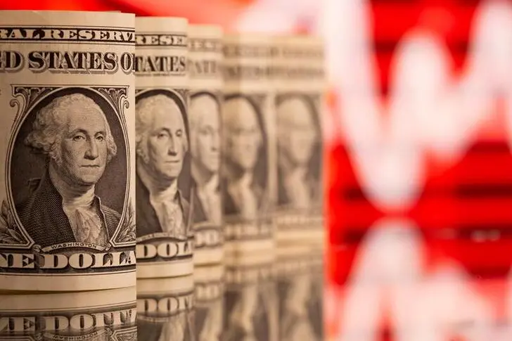 U.S. One dollar banknotes are seen in front of displayed stock graph in this illustration taken, February 8, 2021. , Reuters/Dado Ruvic/Illustration