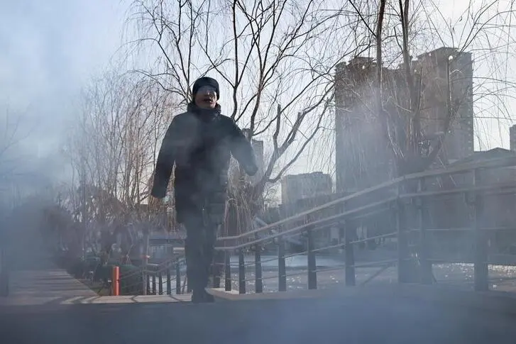 A man walks past a steaming manhole on a cold winter day following an outbreak of the coronavirus disease (COVID-19) in Beijing, China January 6, 2021. , Reuters Images/Thomas Peter