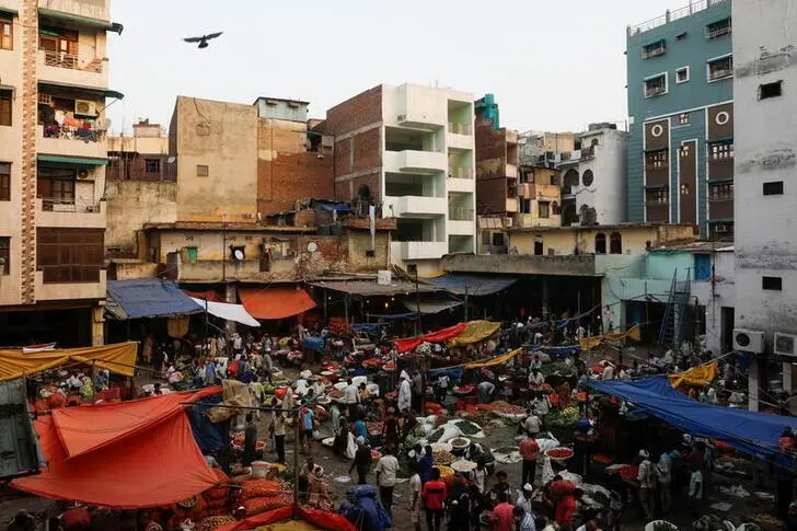 People shop at a crowded wholesale vegetable market after authorities eased coronavirus restrictions, following a drop in the coronavirus disease (COVID-19) cases, in the old quarters of Delhi, India, June 23, 2021. , Reuters Images/Adnan Abidi