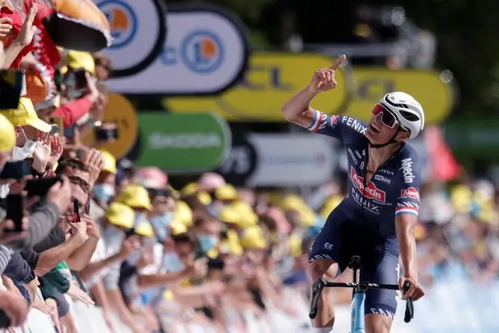 Cycling - Tour de France - Stage 2 - Perros-Guirec to Mur-de-Bretagne Guerledan - France - June 27, 2021 Alpecin\\u00E2\\u20AC\\u201CFenix rider Mathieu van der Poel of the Netherlands celebrates as he crosses the finish line to win the second stage. , Reuters Images/Stephane Mahe     