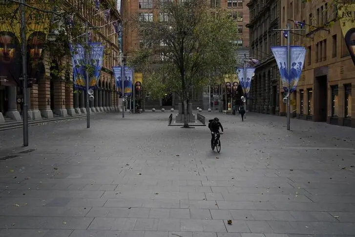 A lone cyclist rides through the empty Martin Place in the city centre during a lockdown to curb the spread of a coronavirus disease (COVID-19) outbreak in Sydney, Australia, July 28, 2021.   , Reuters Images/Loren Elliott