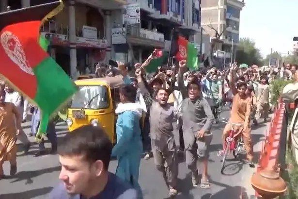 People carry Afghan flags as they take part in an anti-Taliban protest in Jalalabad, Afghanistan August 18, 2021 in this screen grab taken from a video. Pajhwok Afghan News/Handout via REUTERS 