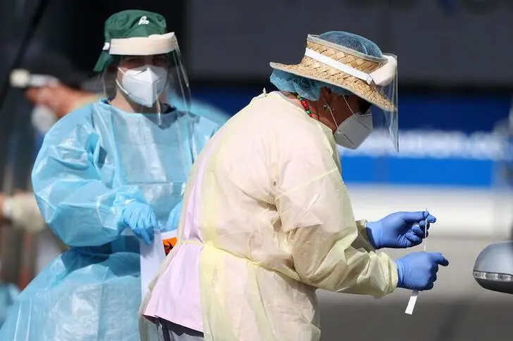 A medical worker administers a COVID-19 test at a testing clinic during a lockdown to curb the spread of a coronavirus disease (COVID-19) outbreak in Auckland, New Zealand, August 26, 2021.  , Reuters Images/Fiona Goodall