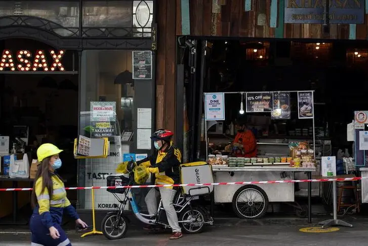 (From L) A construction worker, delivery courier and restaurant staff wear protective face masks while working in the city centre during a lockdown to curb the spread of a coronavirus disease (COVID-19) outbreak in Sydney, Australia, September 9, 2021.   , Reuters Images/Loren Elliott