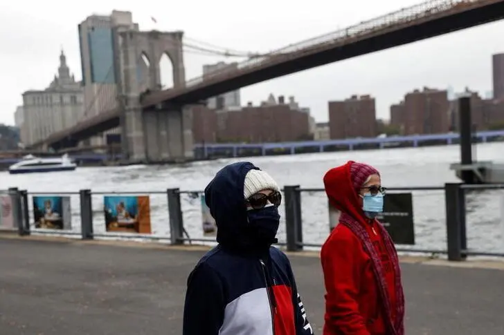 Women walk with protective face masks, amid the coronavirus disease (COVID-19) pandemic, near the Brooklyn bridge in the Brooklyn borough of New York City, U.S., October 13, 2021. , Reuters Images/Shannon Stapleton